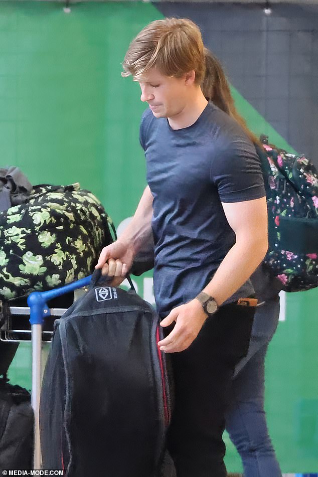 Robert kept his eyes fixed on the crowd as he left the airport with a large amount of luggage.