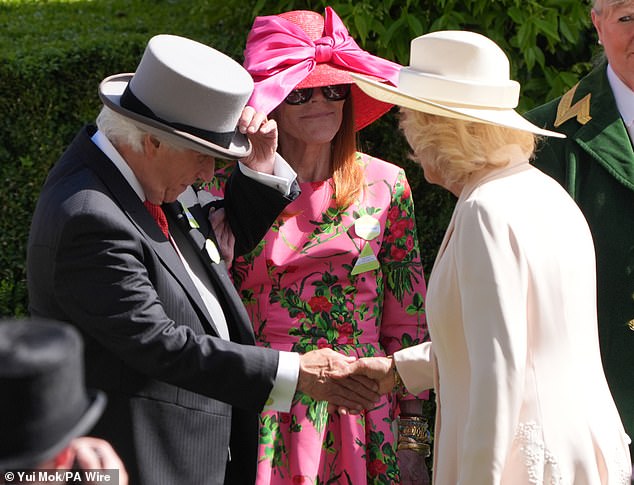 The American actor and director was seen taking off his top hat while shaking hands with Queen Camilla.