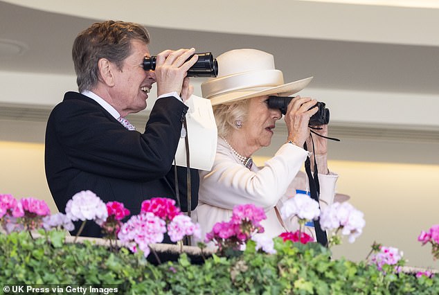 Race director John Warren and Queen Camilla (both pictured) watch the races through binoculars.