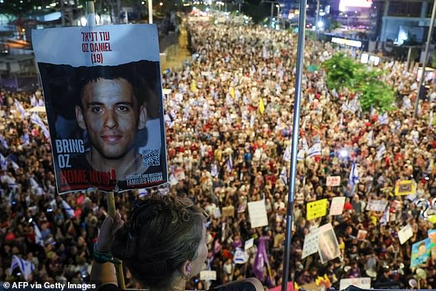 Protesters at Saturday's march held signs of other hostages who were taken to Gaza, including 19-year-old Oz Daniel.