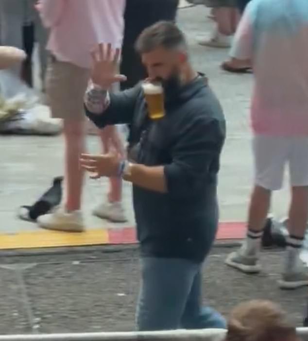 Kelce was also seen walking around Wembley Stadium with a beer hanging from his mouth.