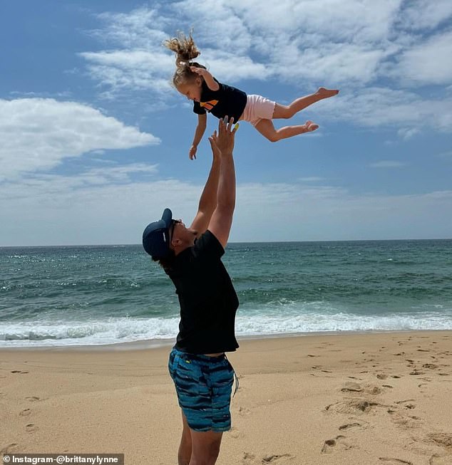 In another photo, Mahomes lovingly tosses his daughter into the air while they were on the beach.