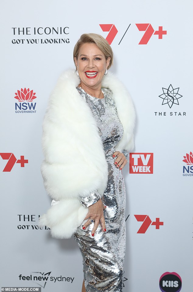 Julia dazzled in a striking silver dress combined with a synthetic fur shawl