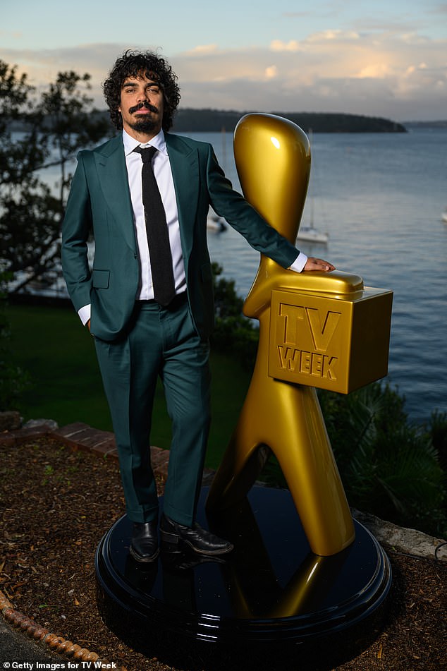 Tony Armstrong looked every inch the handsome presenter in a green suit