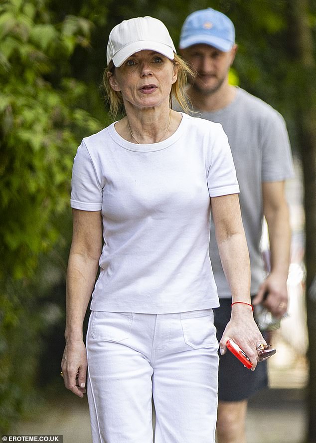 A white baseball cap pulled down over his signature red hair during his latest outing.