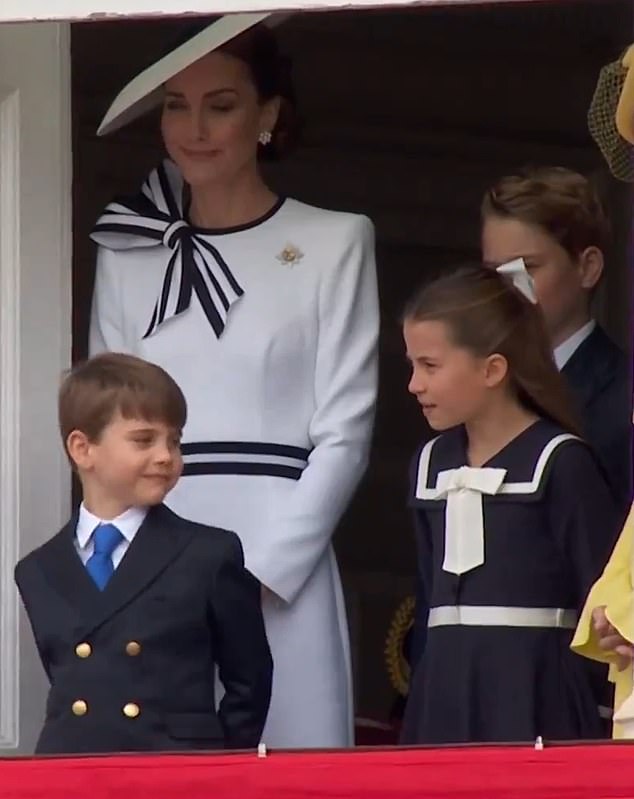 Children in Wales were photographed looking out the window of the Horse Guards building, as King Charles inspected the troops below.