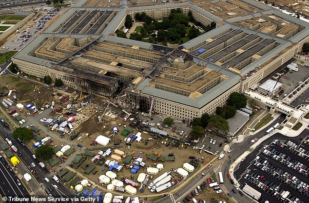 FBI agents, firefighters, rescuers and engineers work at the Pentagon crash site on September 14, 2001, three days after the attacks.