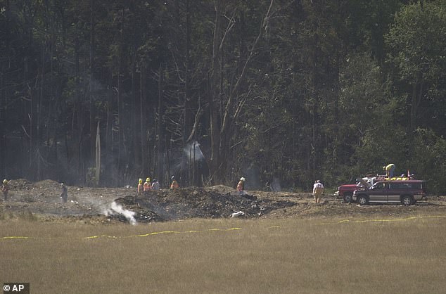 Emergency personnel mark the crash site of United Airlines Flight 93 near Shanksville, Pennsylvania, on the day it crashed. The passengers on the flight ran over the Al Qaeda hijackers, causing the plane to plummet into this field.