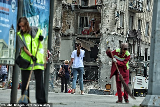 Ukrainians clean the streets and observe the damage caused by Russian bombs in Kharkiv on Sunday