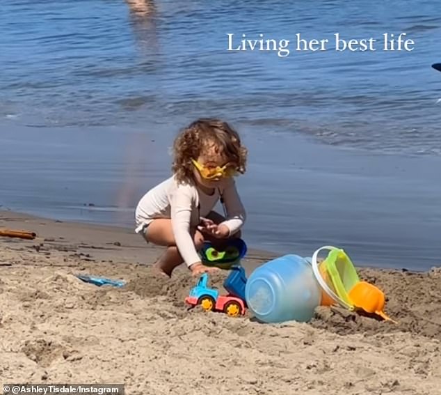 Another sweet clip shows the preschooler enjoying time playing with her toys in the sand.