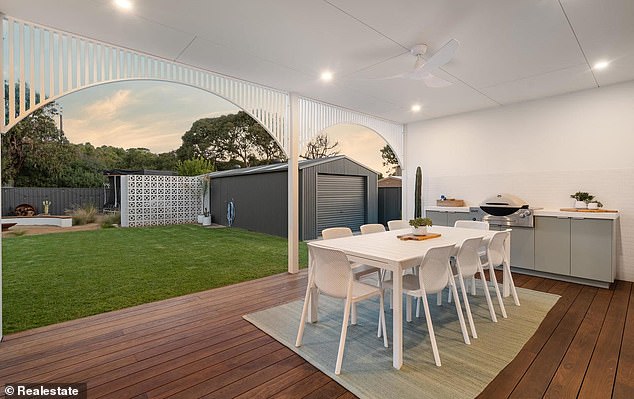 There is also an outdoor dining space with equipped grill overlooking the backyard.