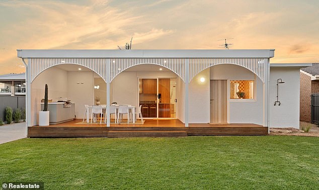 The house is dotted with aloe vera, succulents, native grasses and olive trees.