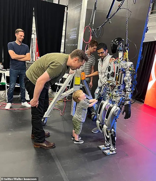 Musk and X, after whom the platform once known as Twitter is named, looking at the robot Optimus