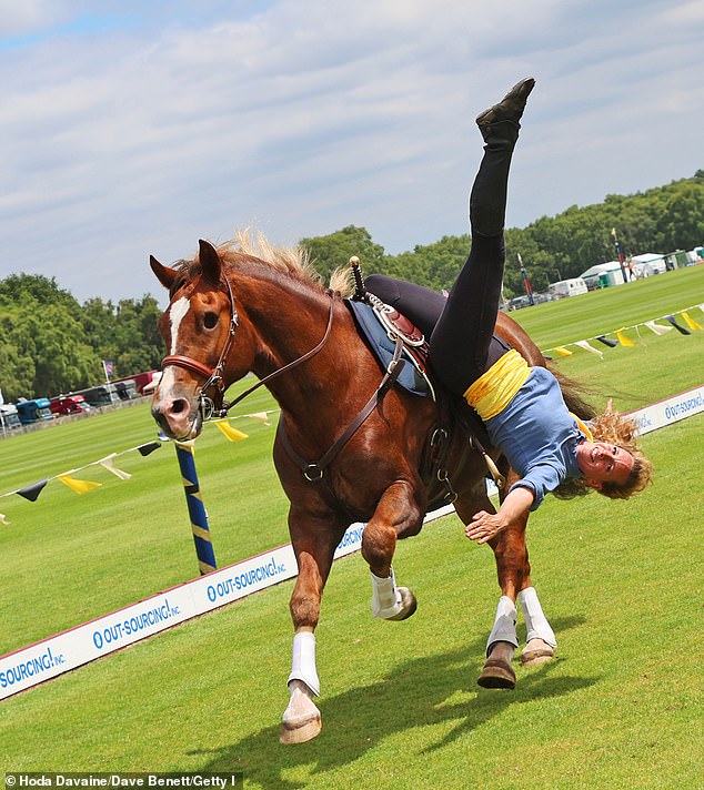 A female stuntwoman was seen hanging from a horse while galloping around the racecourse.