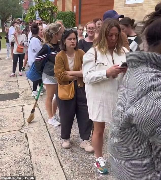 As Sydney faces a rental shortage and cost of living crisis, some people may buy units just for the parking space (photo of potential tenants queuing to inspect a property in Sydney)