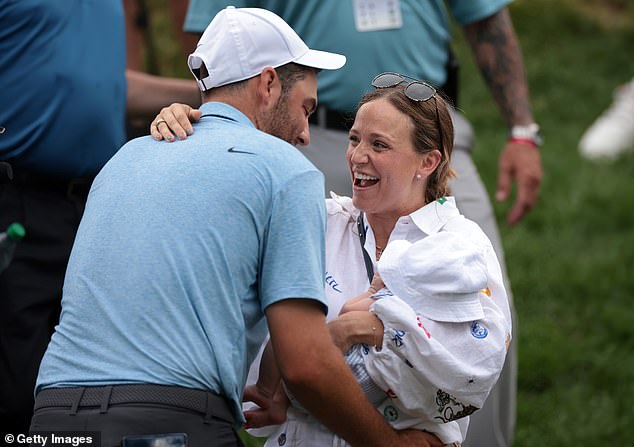 The world No. 1 celebrated with his wife Meredith (right) and newborn Bennett