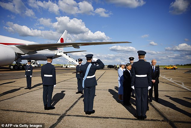 Members of the RAF greet the couple as they make their way to an official vehicle.