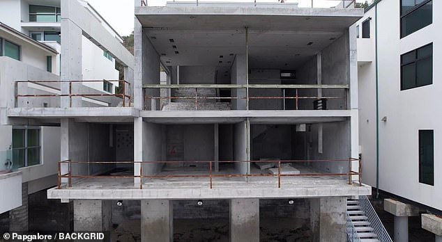 The interior of the house appears to be falling apart and the metal railings are rusting after being exposed to salt air, wind and water.