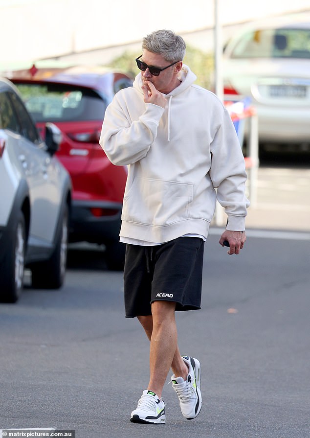 Michael added a pair of black shorts and black and white sneakers, as well as designer sunglasses.