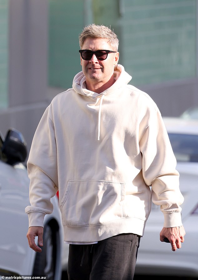 He looked relaxed as he headed to the shops, looking casual in an oversized white sweatshirt.