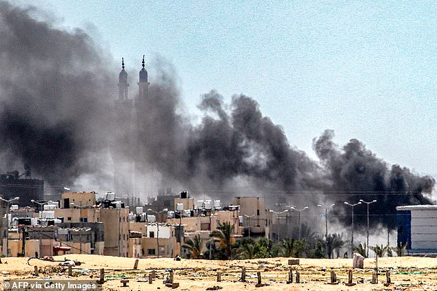 Plumes of smoke rise during ongoing battles in the Sultan neighborhood in northwest Rafah, southern Gaza Strip, June 18, 2024.