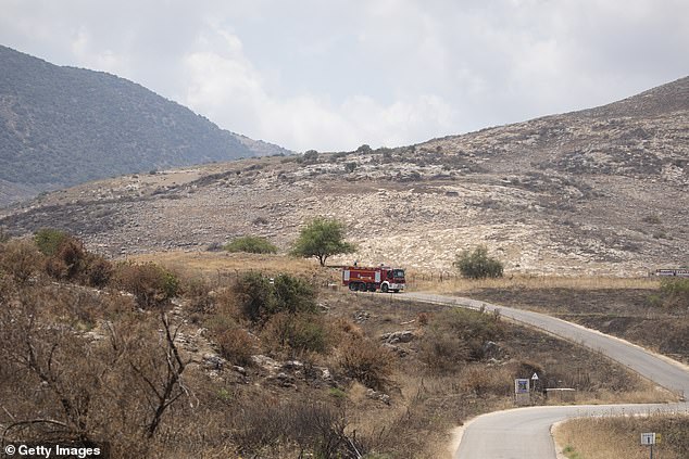 An Israeli fire truck advances toward an attack site following a Hezbollah drone strike from Lebanon on June 23, 2024.