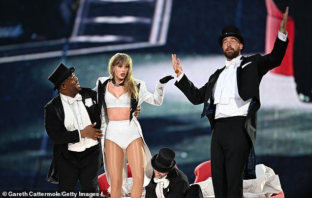 Taylor Swift is joined onstage by her boyfriend Travis Kelce during a costume change at Sunday's show.