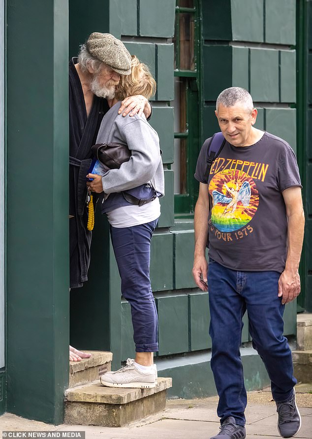 Sir Ian McKellen hugs his friend outside his London home yesterday after his accident.