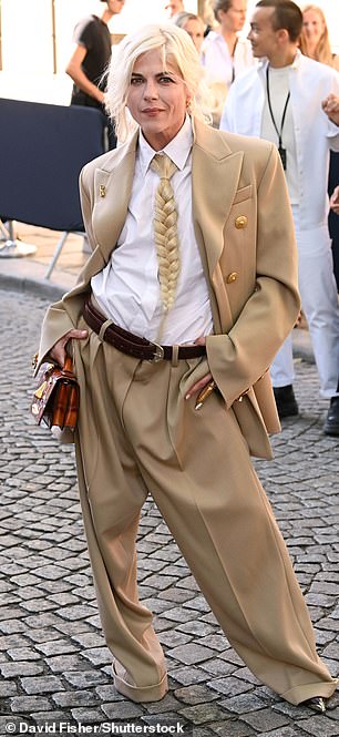 Selma, 52, opted for an androgynous look as she arrived at the show wearing a tan jacket and matching baggy pants.