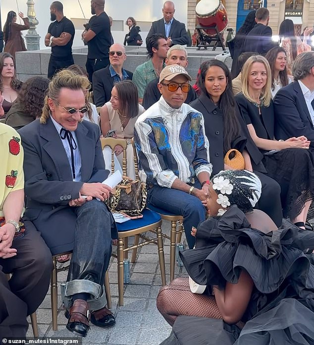 Suzan Mutesi made sure all eyes were on her as she strutted before legendary designer John Galliano (left) and Pharrell Williams in an over-the-top dress that billowed in the wind.