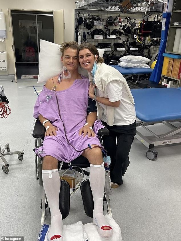 Johnny (pictured with his fiancée Charlottte) remains at the Royal Brisbane and Women's Hospital paralyzed from the waist down.