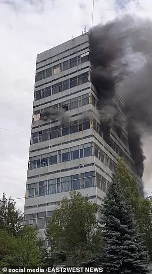 Smoke rises from the high-rise building.