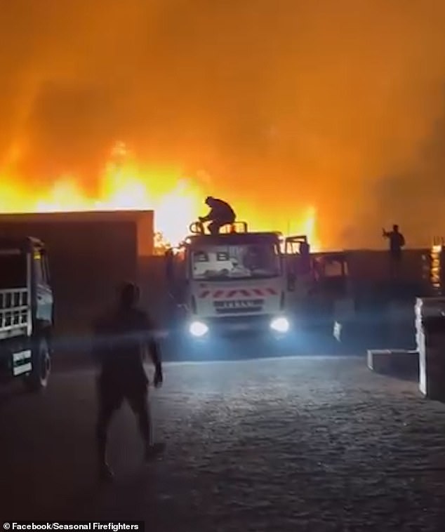 Firefighters work to control a fire in Greece, as the country faces a 