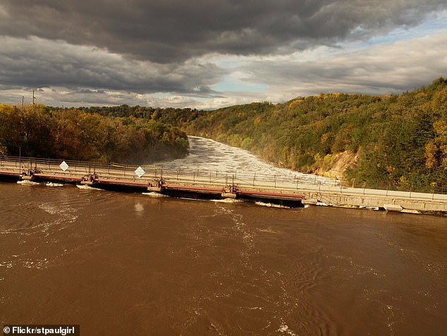 Authorities are warning downstream residents about the risk of stray debris and rising water levels, which have already washed away part of the dam and several nearby buildings.