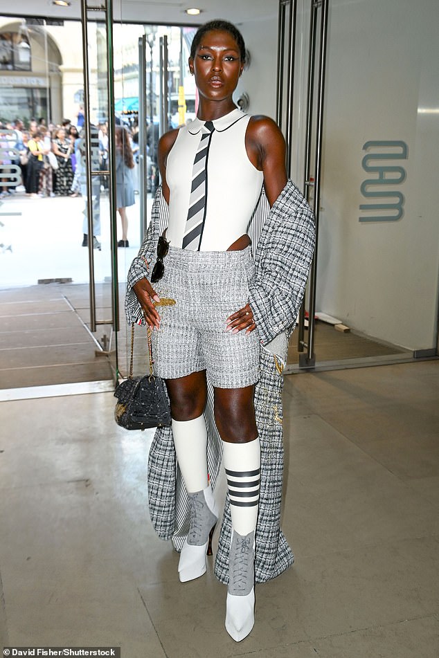 The actress, 37, paired the number with a white racing jumpsuit that featured a gray striped tie and collar print on the front.