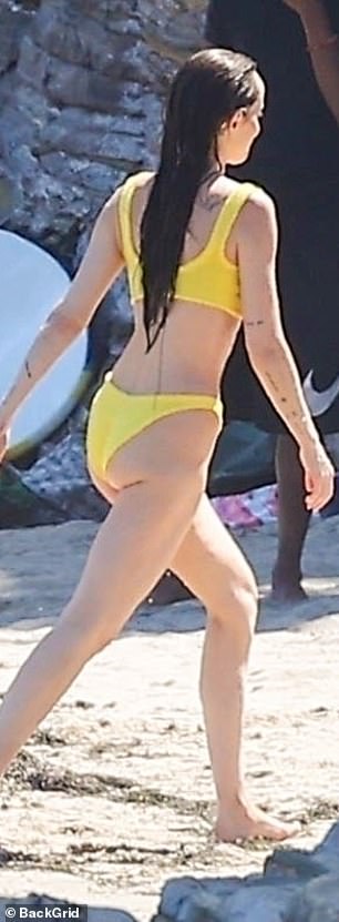 Johnson, who is Ezer and Dolores' godmother, put on an impressive display as she walked across the sand in a fun yellow bikini.