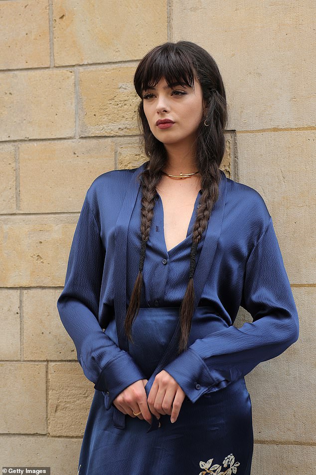 The 19-year-old posed for photos in a striking blue satin dress, which included gold details depicting birds and flowers.