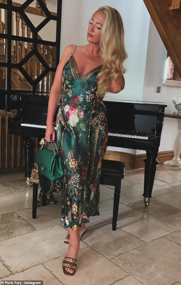 While Tyson opted for a polo shirt and shorts, Paris stunned in a long, low-cut green floral dress with a quilted Chanel bag that costs a whopping £7,000.