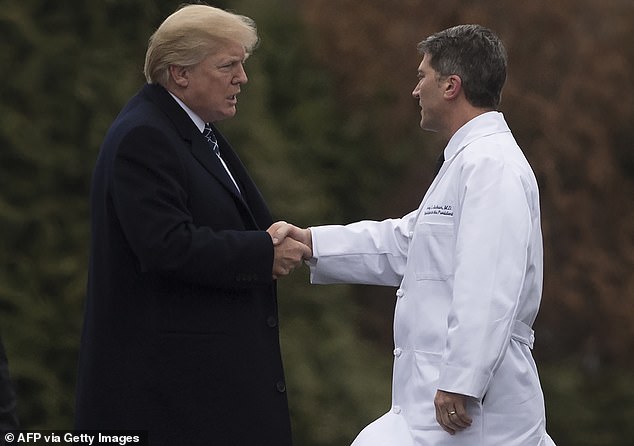 US President Donald Trump shakes hands with White House physician Rear Admiral Dr. Ronny Jackson after his annual physical at Walter Reed National Military Medical Center in Bethesda, Maryland, January 12, 2018.