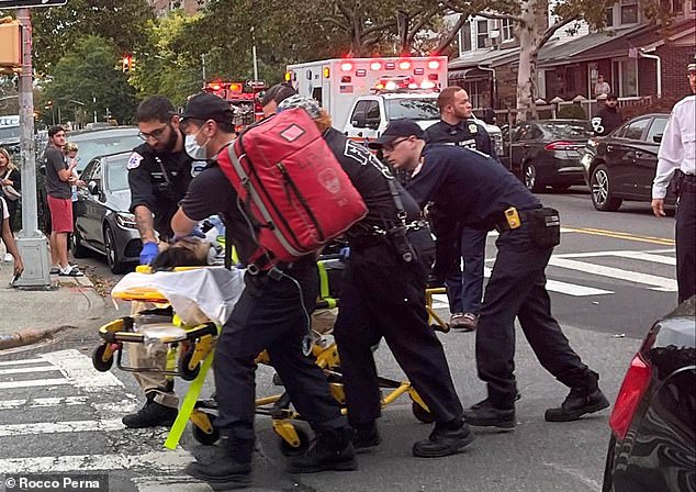 After firing his gun, Wu waited in the house until police arrived and calmly confessed to the crimes. (In the photo: one of the victims is removed from the scene on a stretcher)