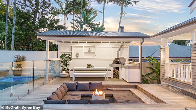 The outdoor dining area also features a pizza oven and barbecue, as well as a sunken fire pit area, perfect for entertaining.