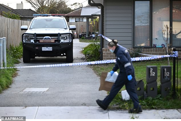 Forensic agents are seen arriving at the cordoned-off property.