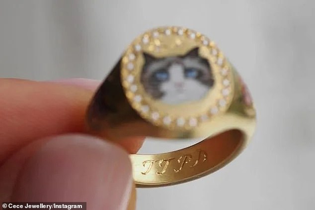 The gold ring also features an image of Taylor's famous cat, Benjamin Button, as well as an engraving of the initials from her new album, The Tortured Poets Department.