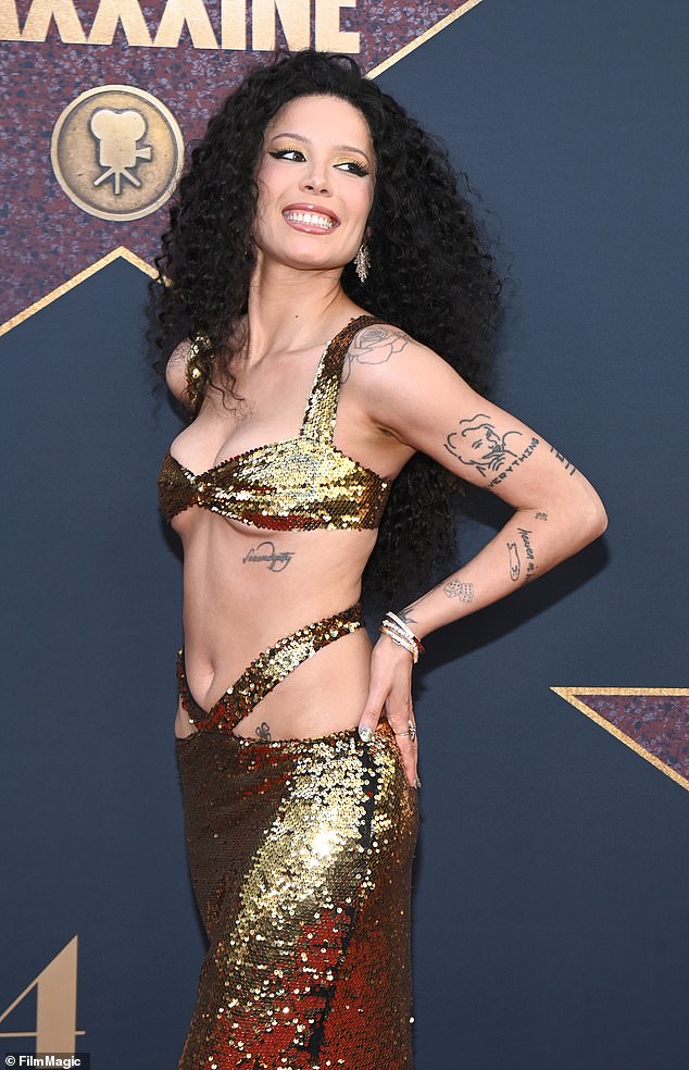 The singer, born Ashley Frangipane, teased her toned tummy and hips in a gold sequin dress with a strappy center cutout.