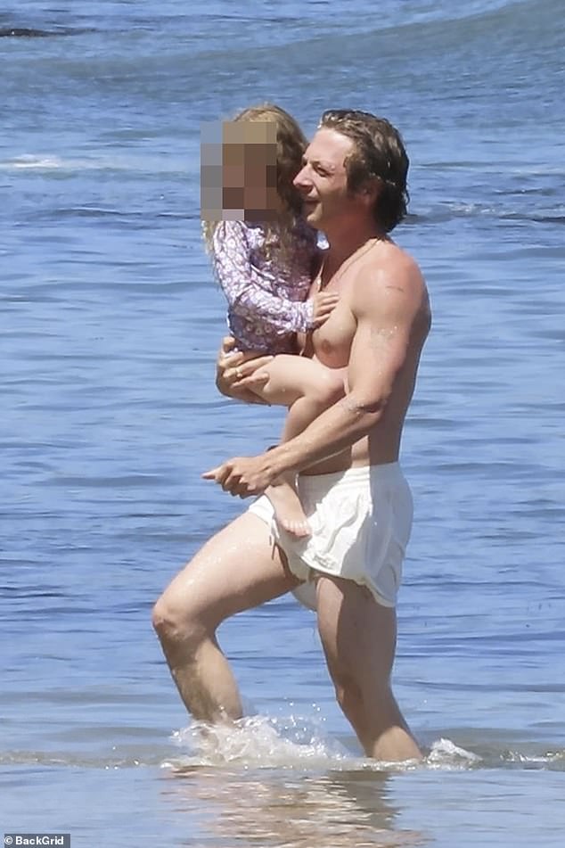 He showed off his muscular arms as he emerged from the sea with his daughter, who he shares with ex-wife Addison Timlin.