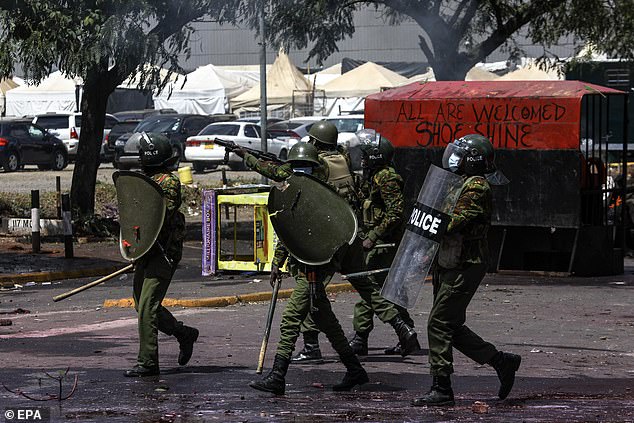 Police prepare to fire tear gas at protesters during a protest against proposed tax increases.