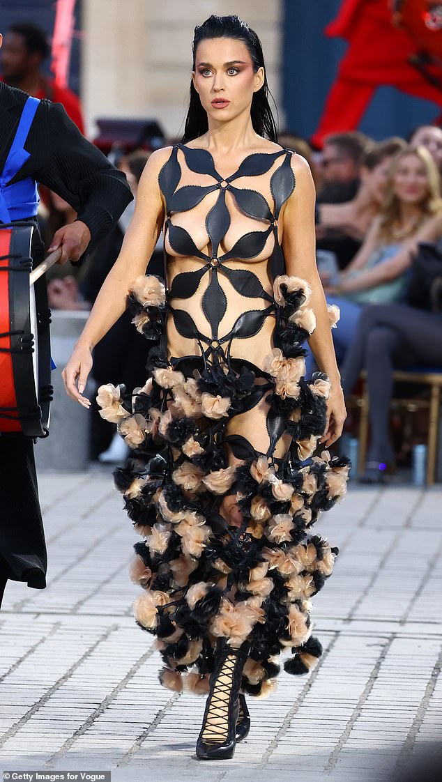 Katy went completely nude in a geometric cut-out dress as she hit the catwalk on Sunday night.