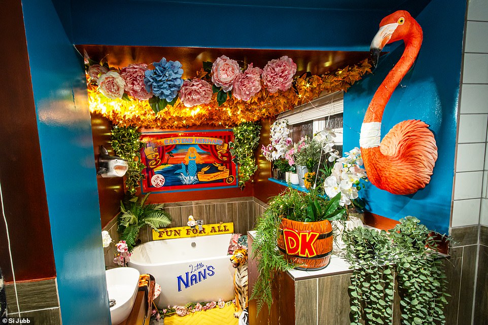 'The Eastend Mermaid Bath & Shower Room' (pictured) is decorated with artificial flowers and has a flamingo bust protruding from the wall.