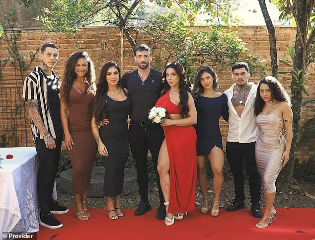 Onlyfans adult content creators Máximo García (fourth from left) and his wife, Luiza Marcato, (fourth from right) with their groomsmen and bridesmaids.