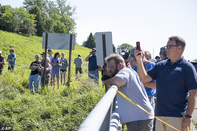 Spectators can see damage to the Rapidan Dam in Rapidan on Monday